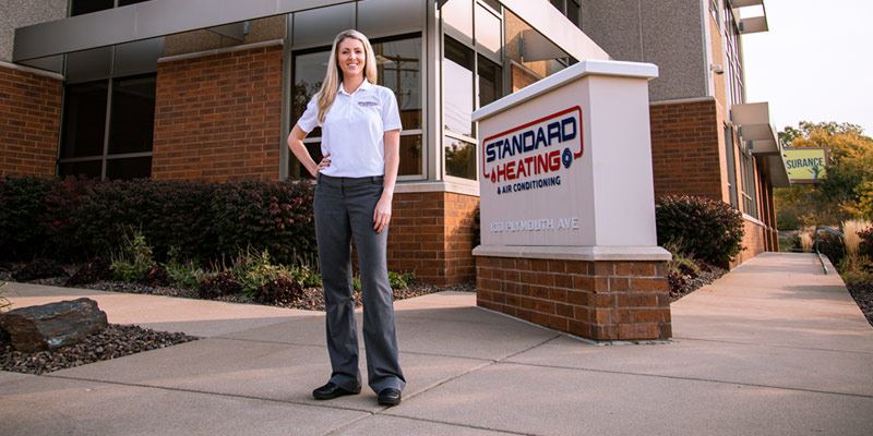 Image of Claire in Front of Standard Heating & Air Conditioning Building 